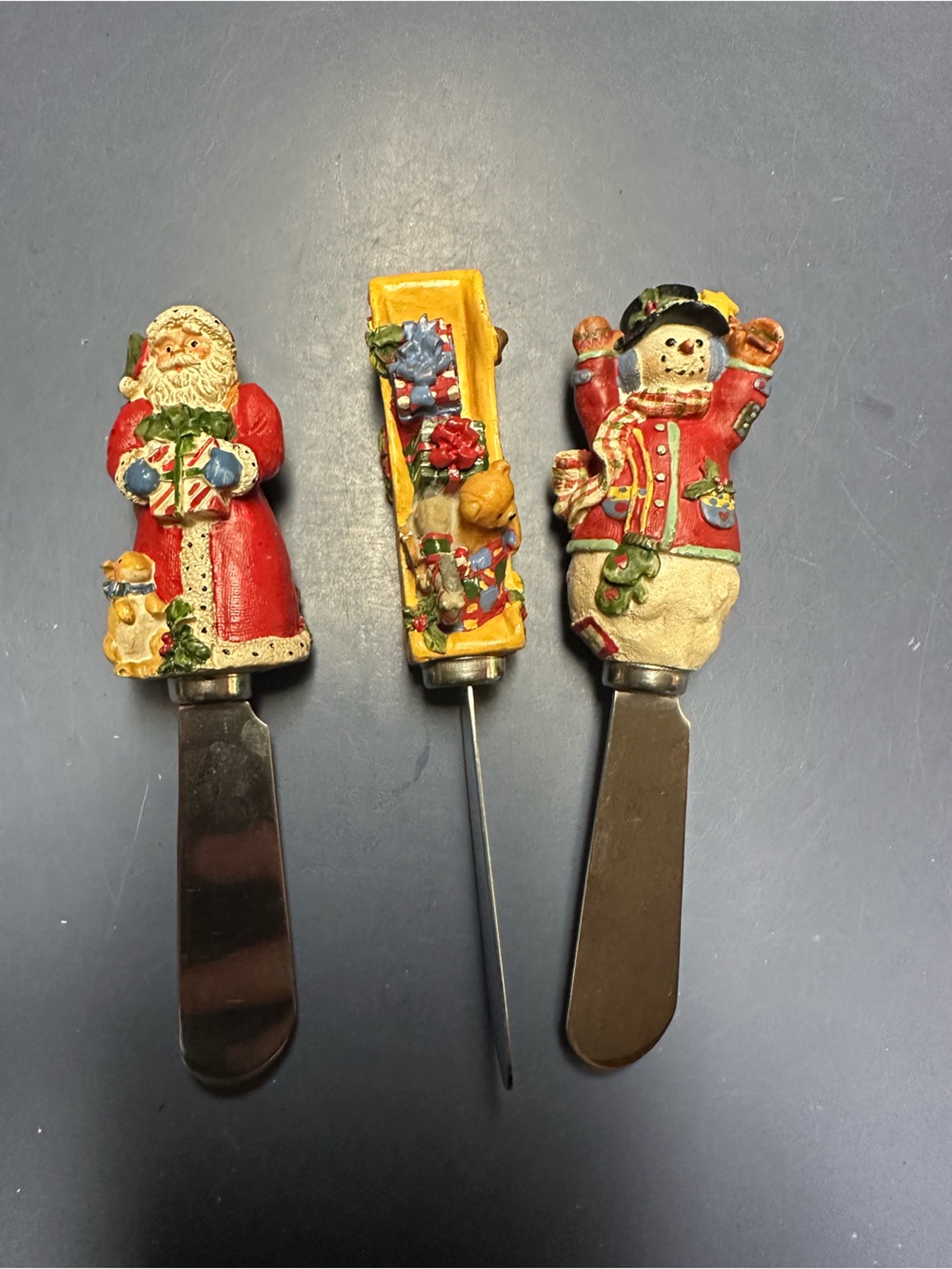 a vintage set of three Christmas holiday cheese spreaders